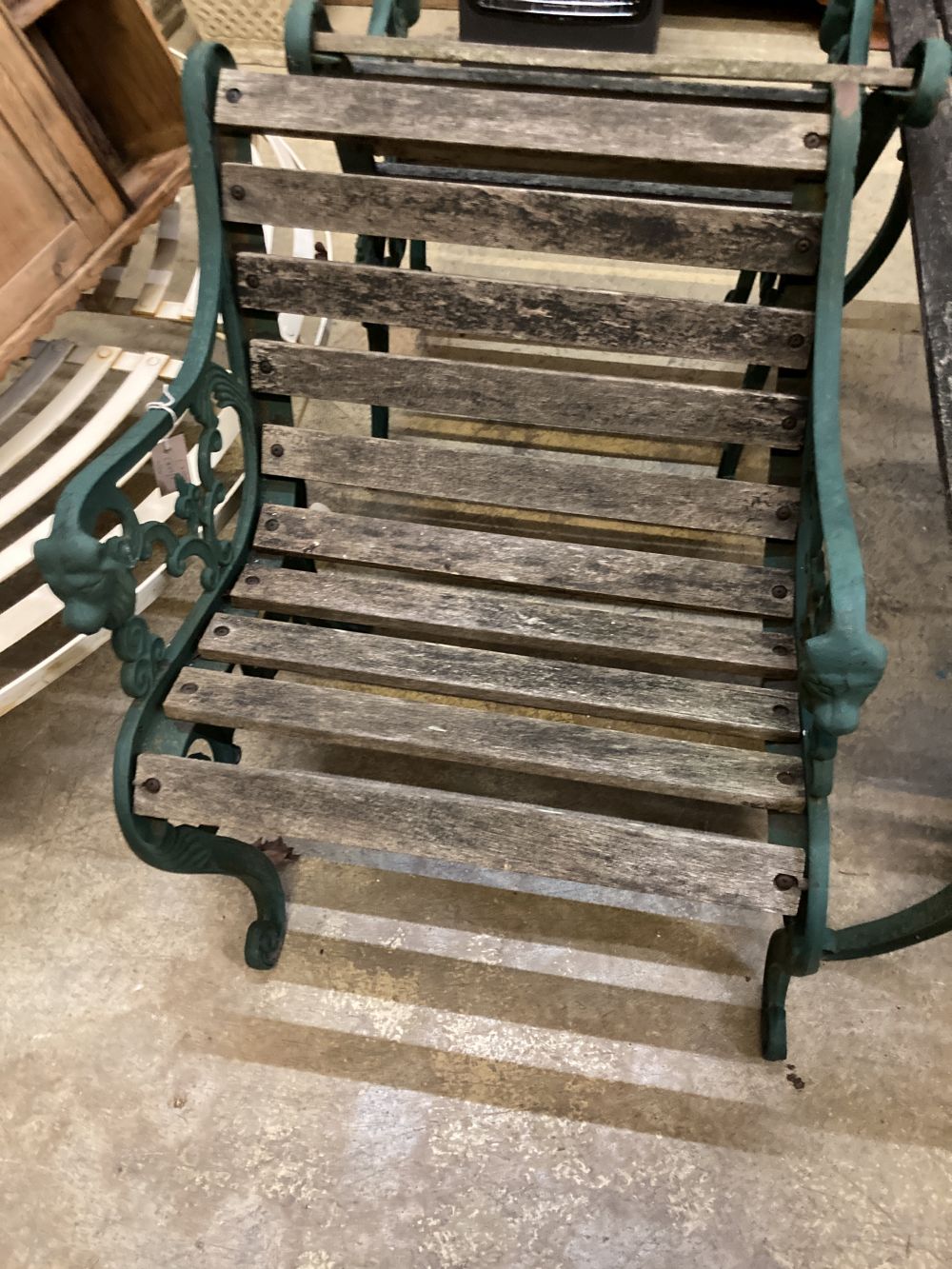 Four cast metal slatted wood garden armchairs and matching rectangular table, table 126 x 67cm, height 65cm